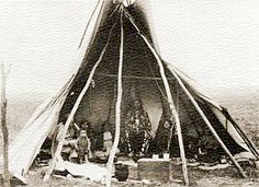 Figure 1.3 Pawnee Indians inside a tipi made by them. These tipi’s have the basic bucksin, lodge poles, fire pit inside, and held by a horse or a dog. 